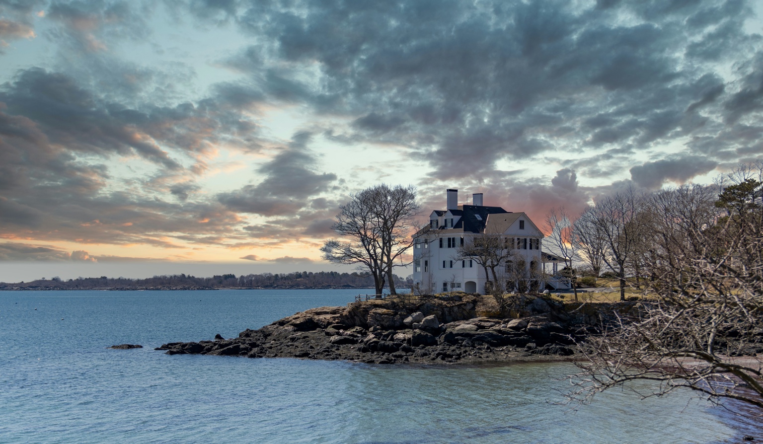 Massachusetts North Shore waterfront estate at dusk on rocky coastline