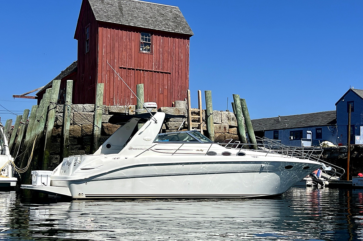 White cabin cruiser at Motif No. 1 in Rockport, Massachusetts